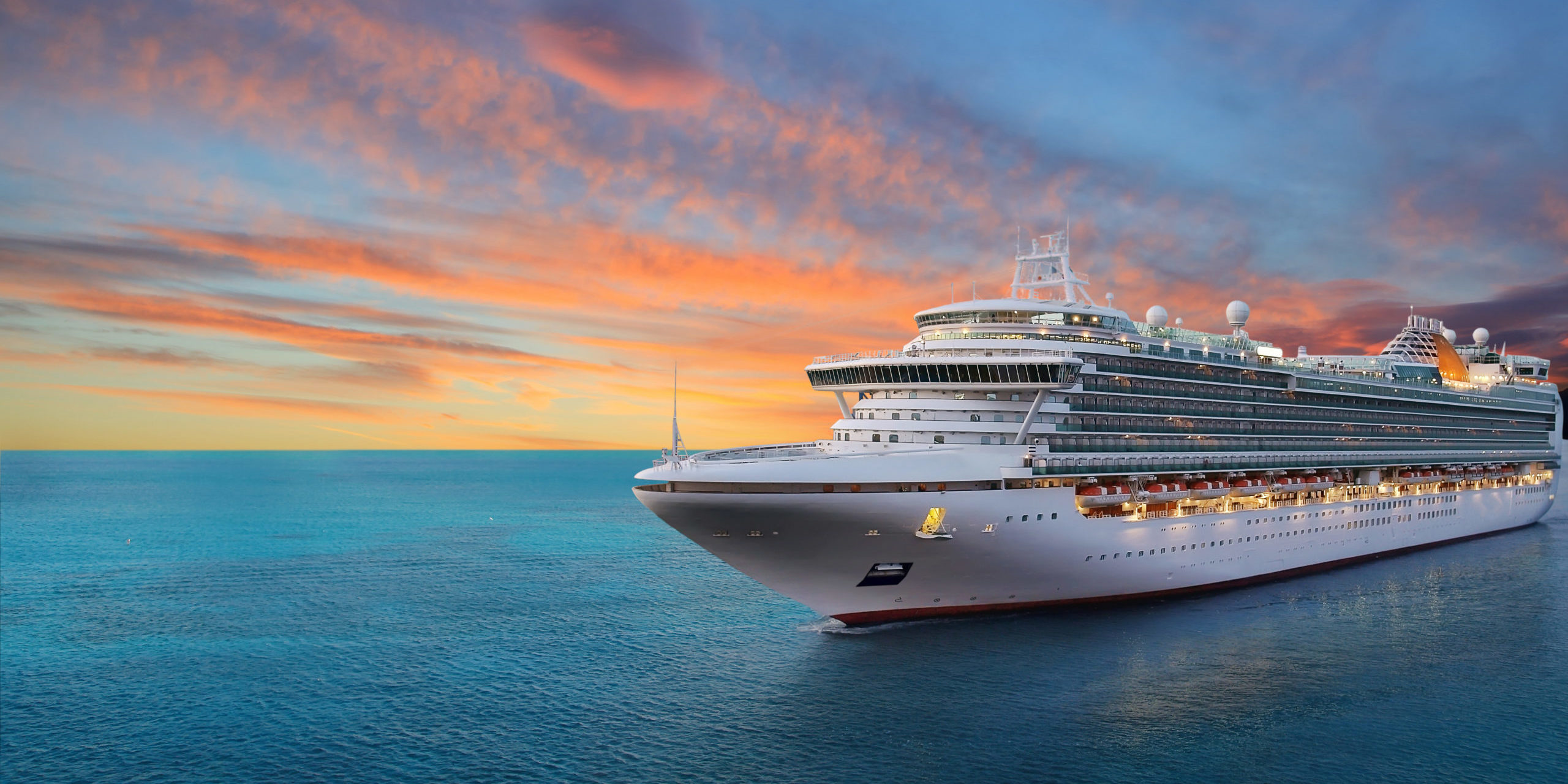 Luxury cruise ship sailing to port on sunrise