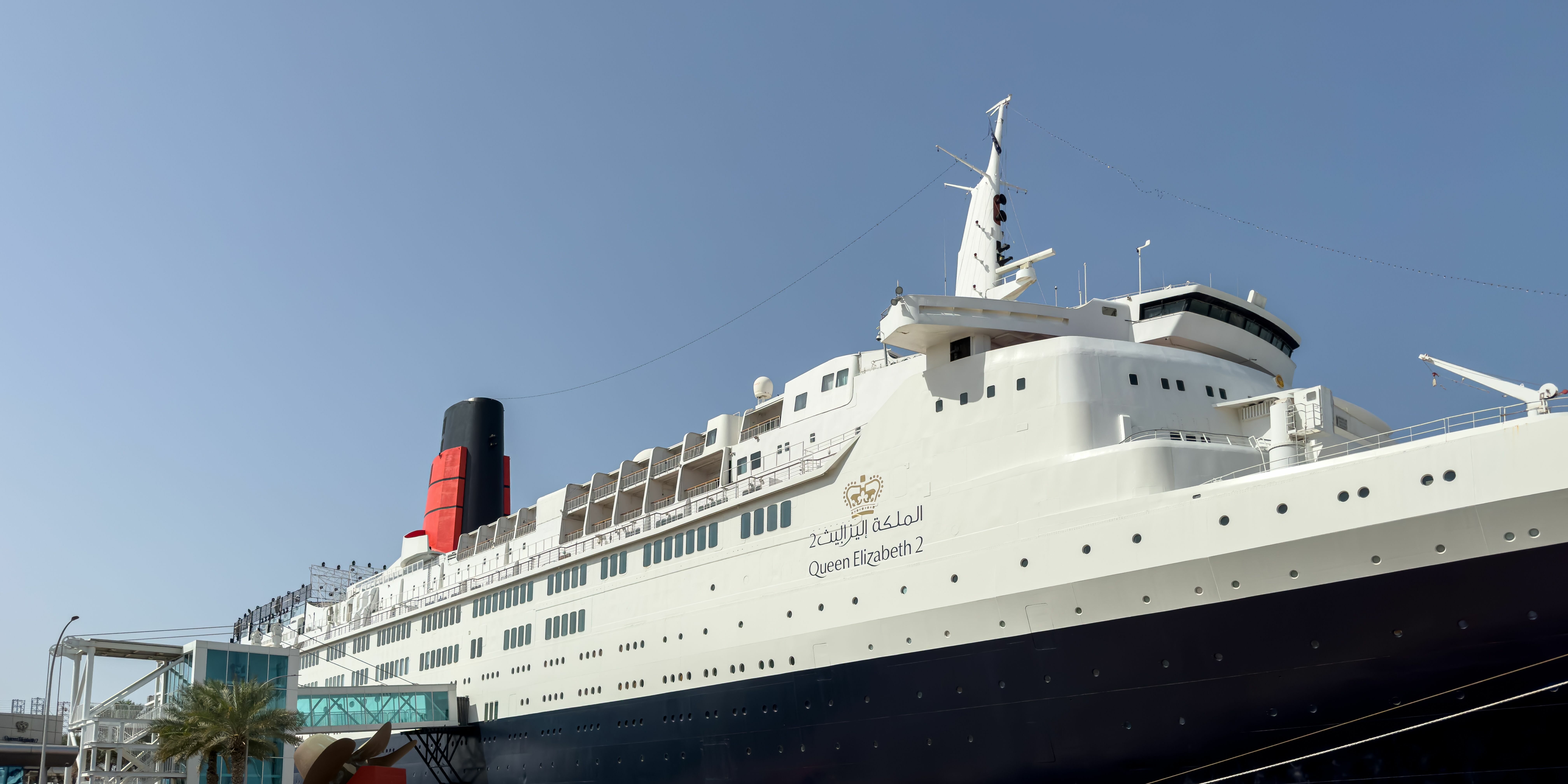 Luxury ocean liner Queen Elizabeth 2 docked in the harbor.