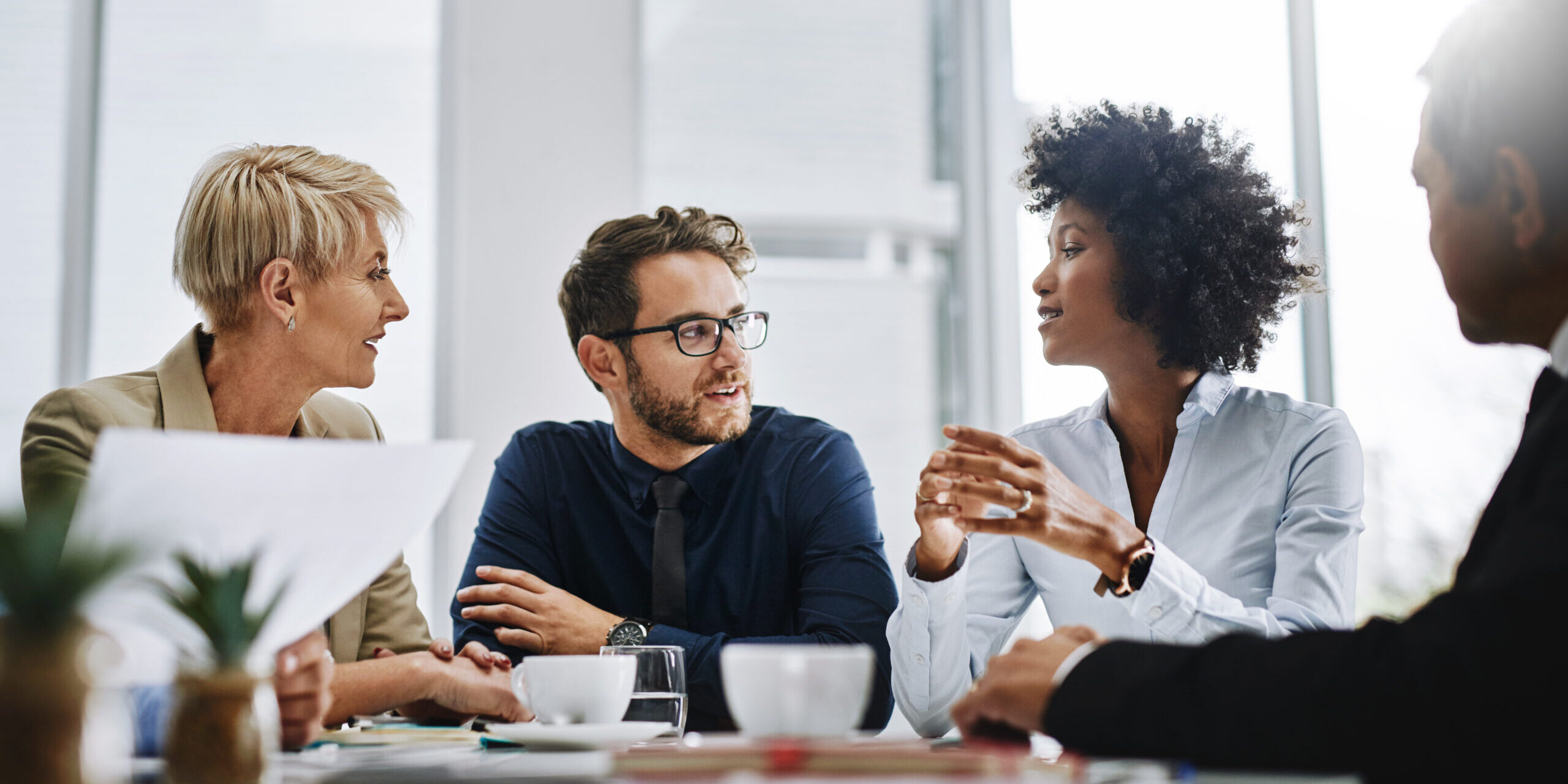 Give us difficult and well show you easy. Shot of a group of businesspeople sitting together in a meeting.